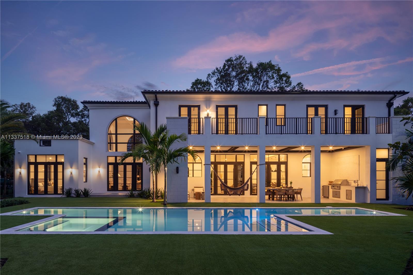 Rear facade and pool at dusk