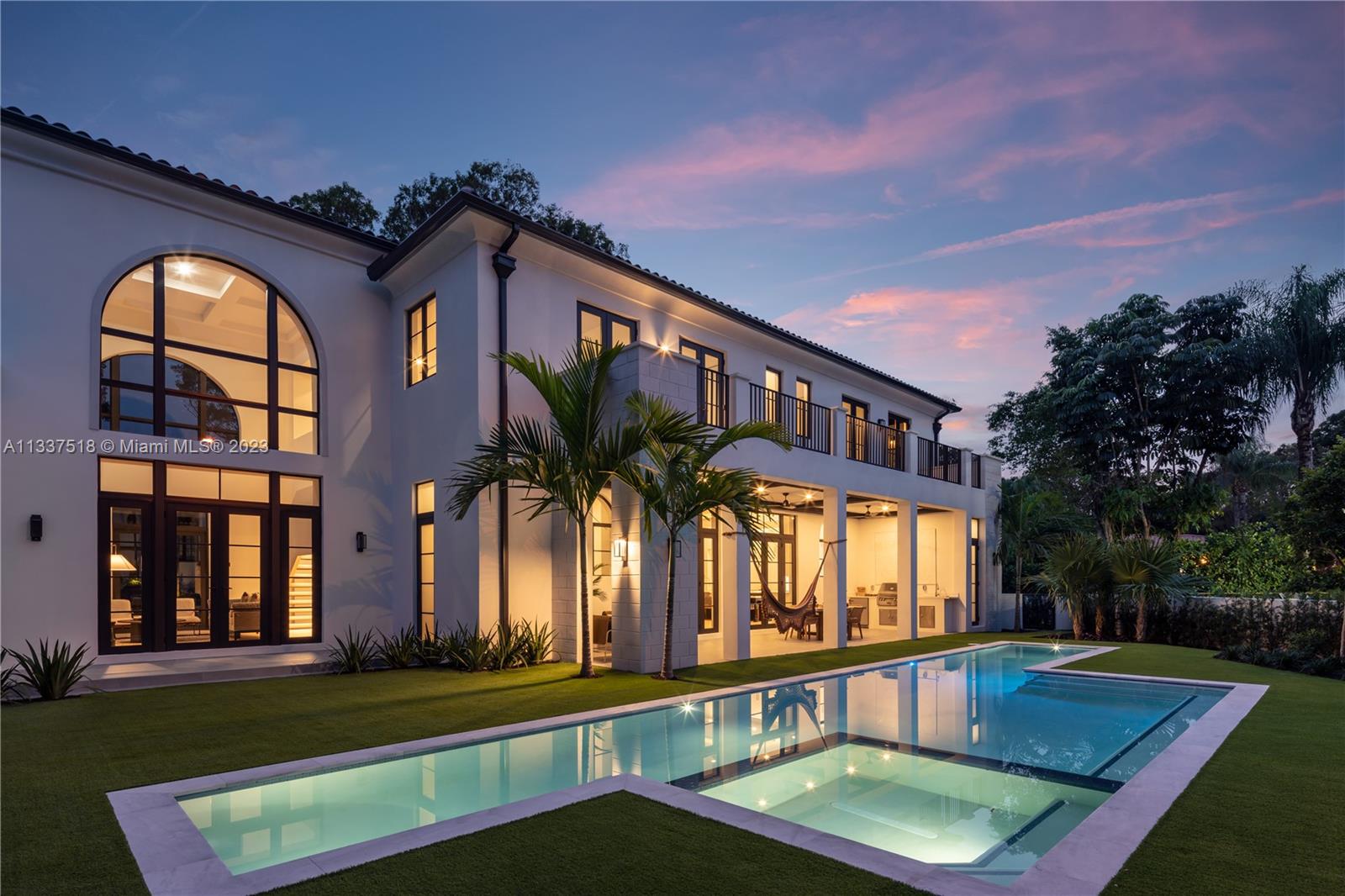 Rear facade and pool at dusk