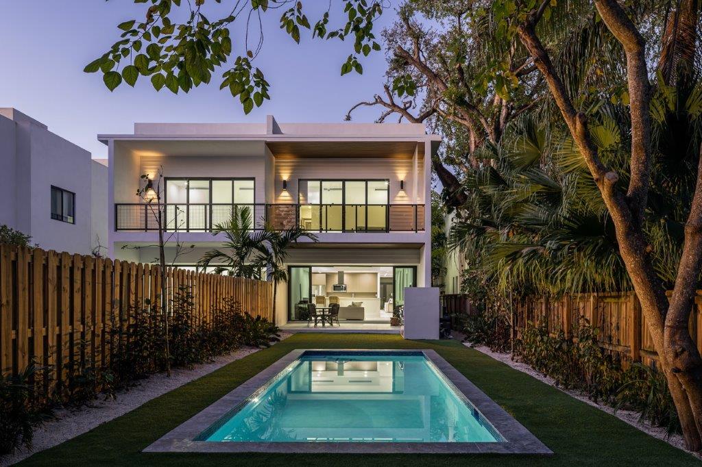 Modern residence at dusk with pool