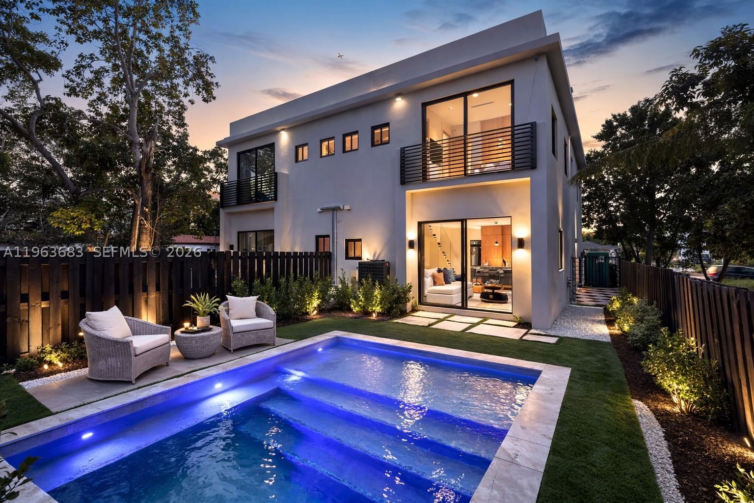 House at dusk with lit pool